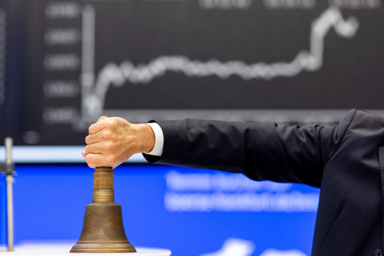 IPO bell in front of DAX board (portrait)